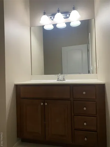 a bathroom with a sink vanity and a mirror