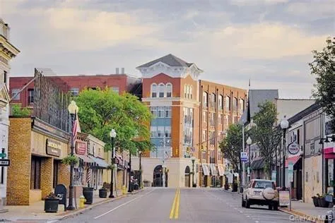 a city street lined with buildings and cars