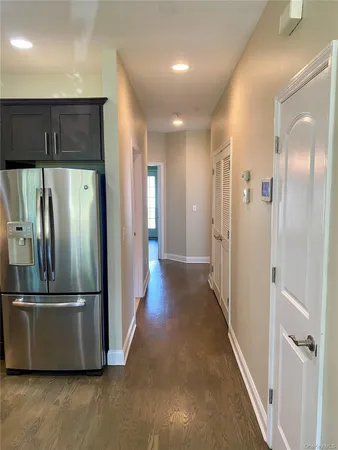 a view of a refrigerator in kitchen and wooden floor