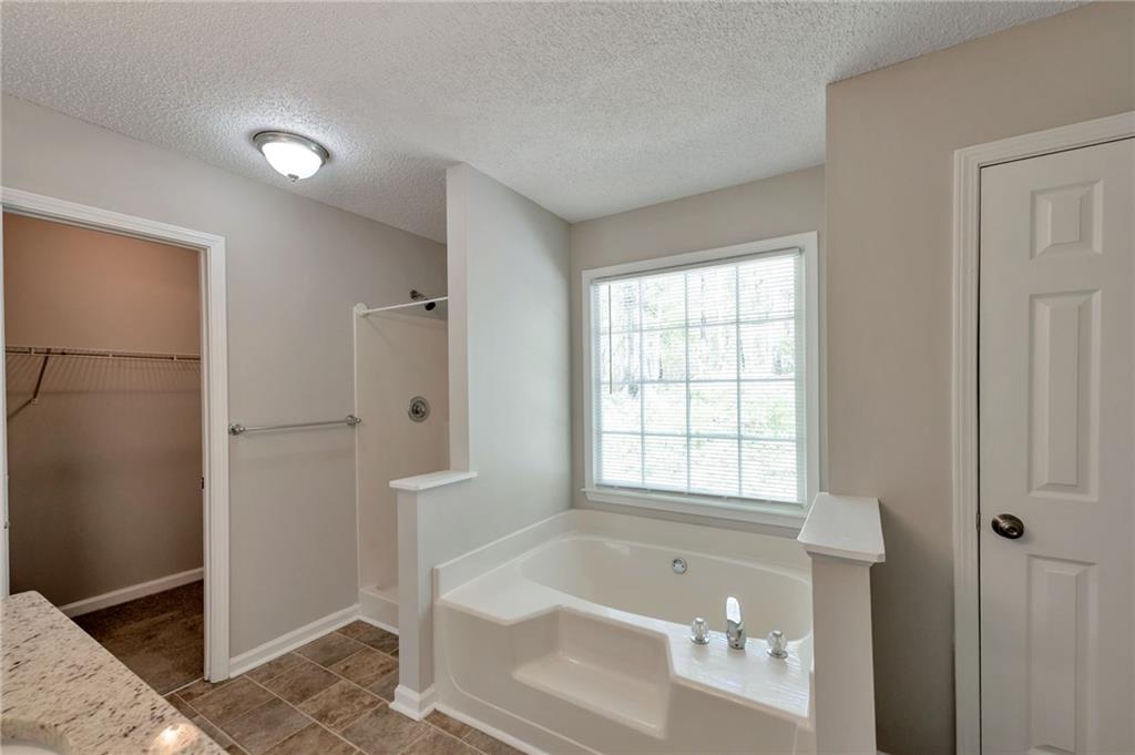 252 Amber Way Dallas, GA 30157 - Photo 22 of 40 a bathroom with a bathtub and shower