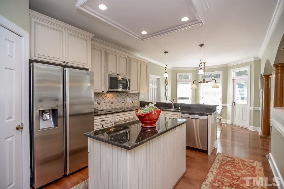 1709 West Paces Ferry Road Raleigh, NC 27613 - Photo 3 of 23 a kitchen with stainless steel appliances granite countertop a sink stove and refrigerator
