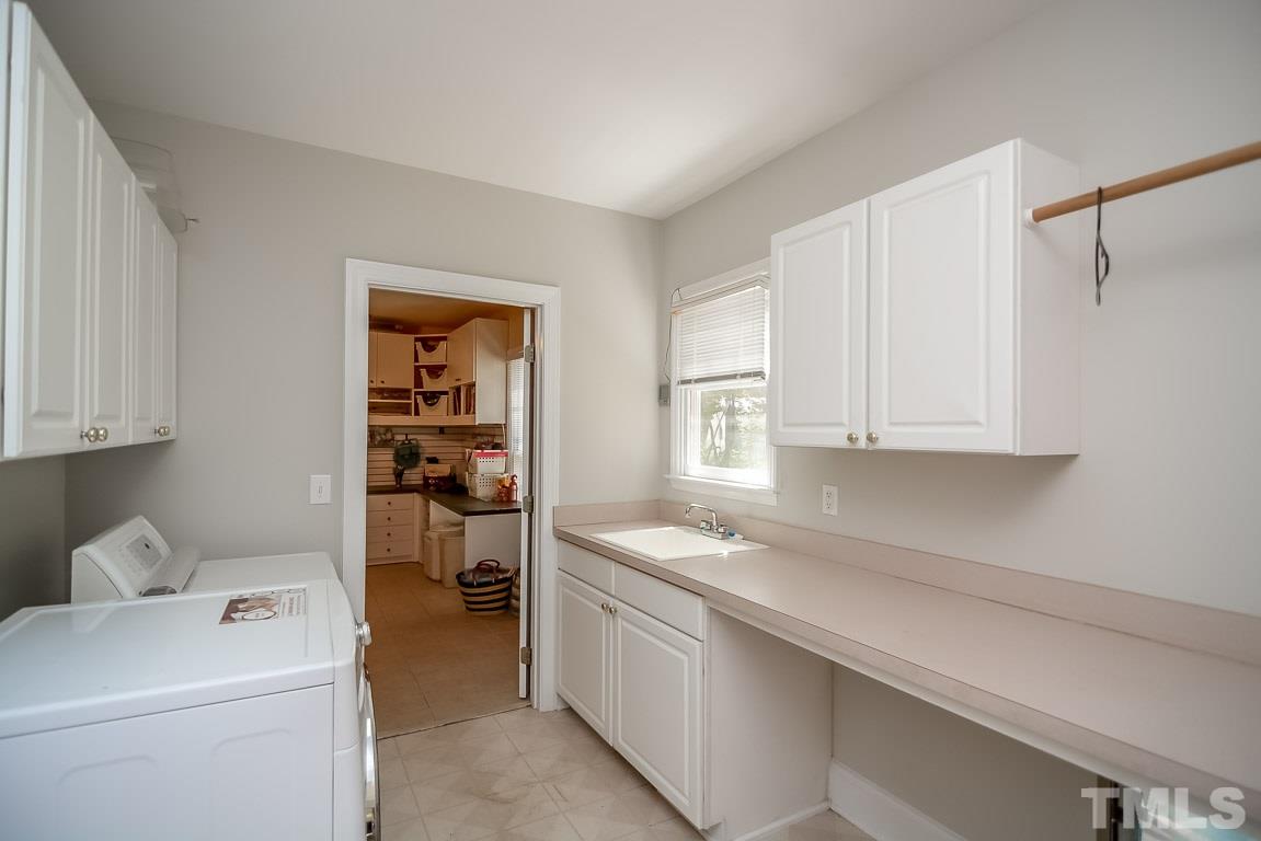 1709 West Paces Ferry Road Raleigh, NC 27613 - Photo 22 of 23 a utility room with cabinets washer and dryer