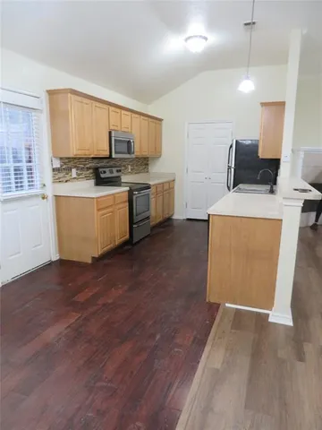 a kitchen with a sink and cabinets