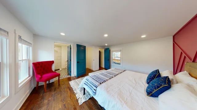 a spacious bedroom with a bed and a couch