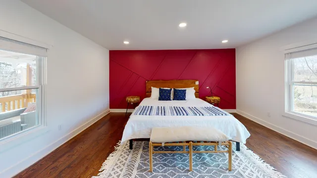 a bed sitting in a room next to a window