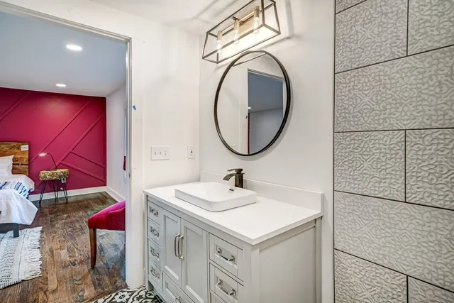 a bathroom with a sink vanity and a mirror