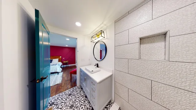 a bathroom with a sink mirror and toilet