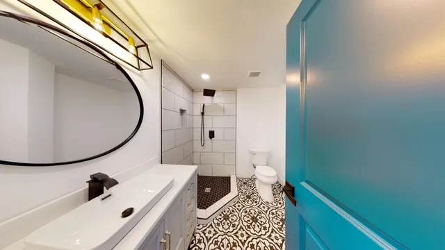 a bathroom with a sink a toilet and a mirror