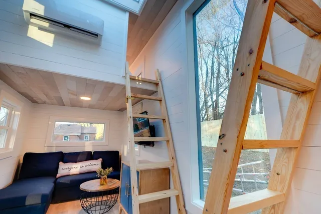 a front view of a house with outdoor seating