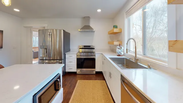 a kitchen with a sink stove and cabinets
