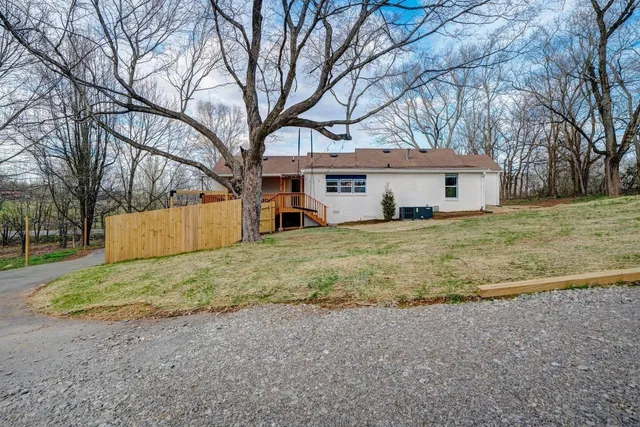 a house that has a tree in front of it