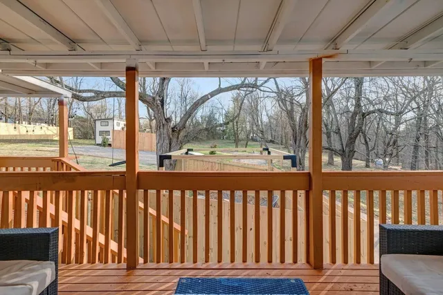a view of a porch with wooden floor