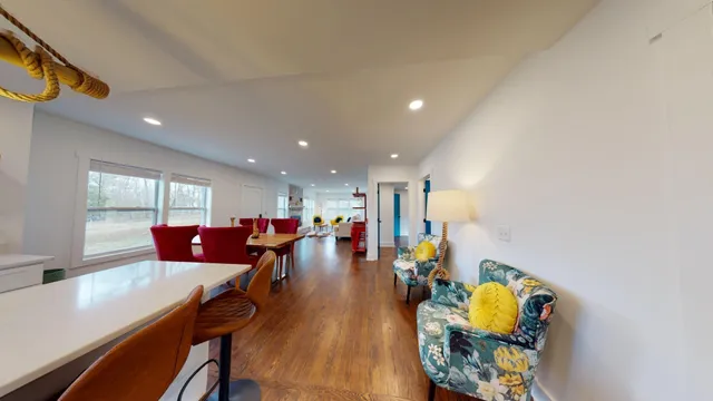 a living room with dining room and wooden floor