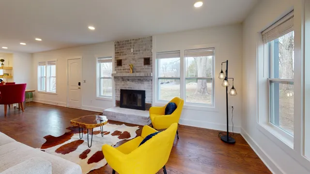 a living room with furniture pool table and a fireplace