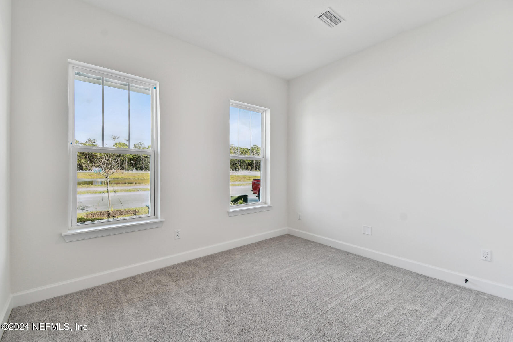 5608 Pathfinder Road Jacksonville, FL 32224 - Photo 17 of 36 an empty room with windows