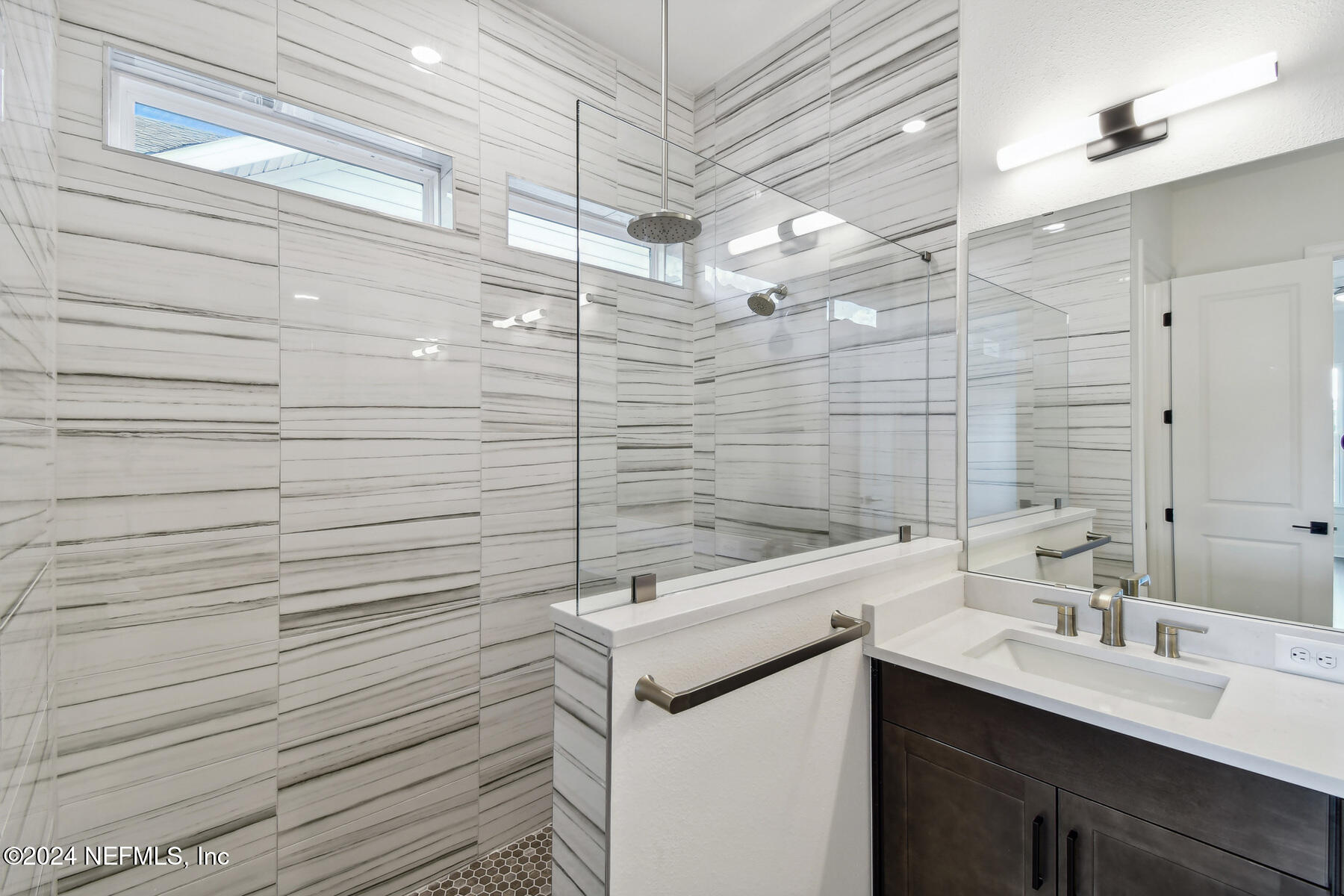 5608 Pathfinder Road Jacksonville, FL 32224 - Photo 33 of 36 a bathroom with a sink and mirror