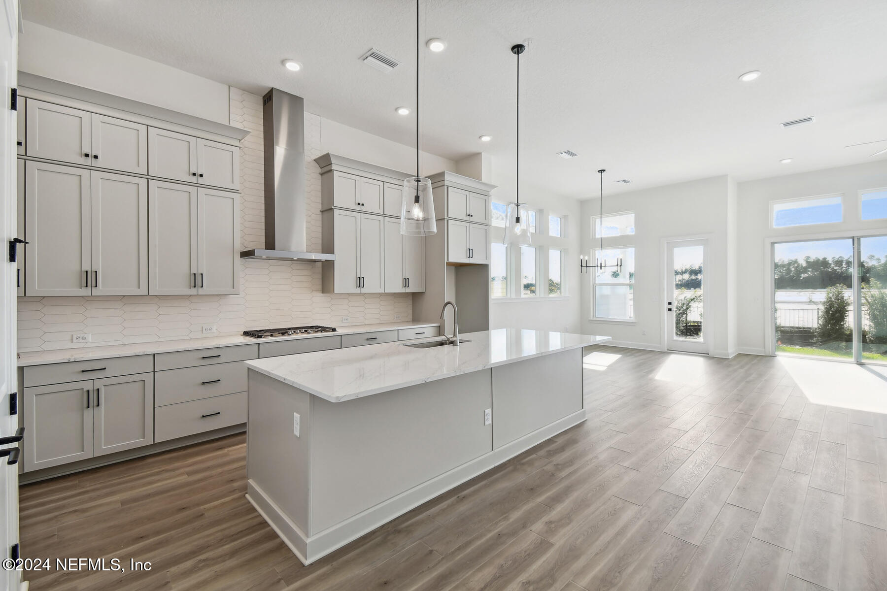 5608 Pathfinder Road Jacksonville, FL 32224 - Photo 8 of 36 a large kitchen with stainless steel appliances kitchen island granite countertop a stove a sink a center island and a wooden cabinets
