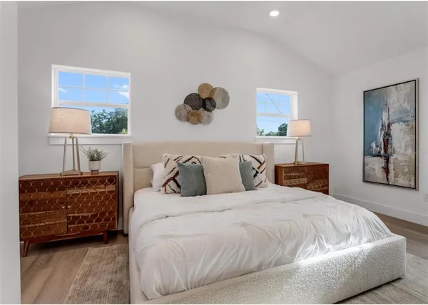 a bedroom with a bed and a painting on the wall