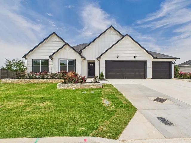 a front view of house with yard patio and green space