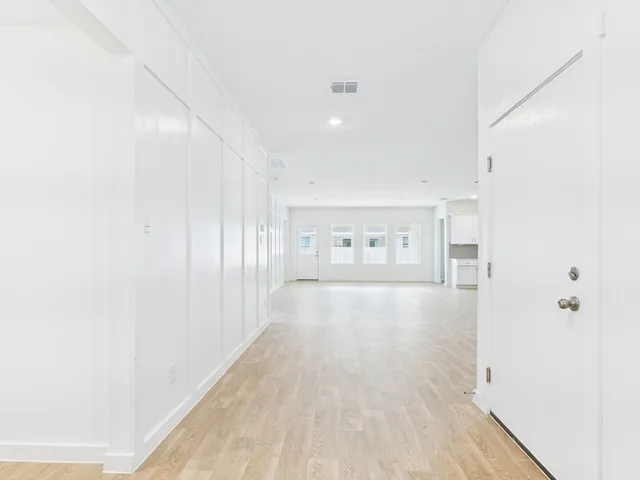 a view of hallway with wooden floor