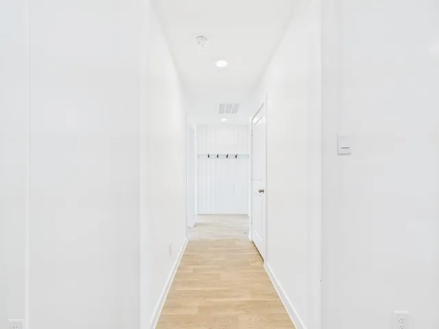 a view of a hallway with white walls