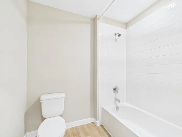 a bathroom with a toilet and a bathtub