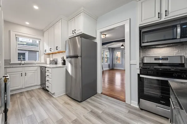 a kitchen with a refrigerator stove and sink