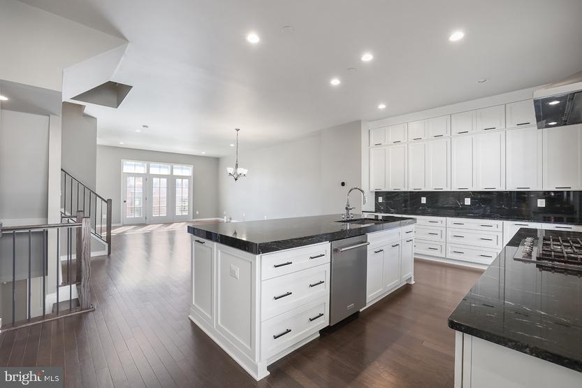 22170 Penelope Heights Terrace Ashburn, VA 20148 - Photo 13 of 61 a kitchen with stainless steel appliances granite countertop a stove a sink and white cabinets with wooden floor