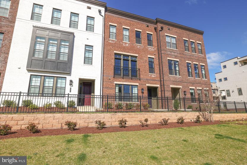 22170 Penelope Heights Terrace Ashburn, VA 20148 - Photo 3 of 61 a front view of a residential apartment building with a yard
