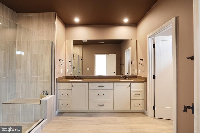 22170 Penelope Heights Terrace Ashburn, VA 20148 - Photo 33 of 61 a large bathroom with a large mirror vanity and shower