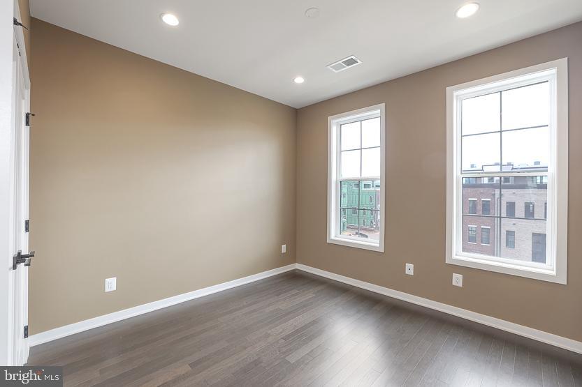 22170 Penelope Heights Terrace Ashburn, VA 20148 - Photo 35 of 61 an empty room with wooden floor and windows