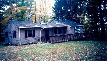 1239 Reservoir Road Otis, MA 01029 - Photo 1 of 2 a view of a house with a backyard and wooden fence