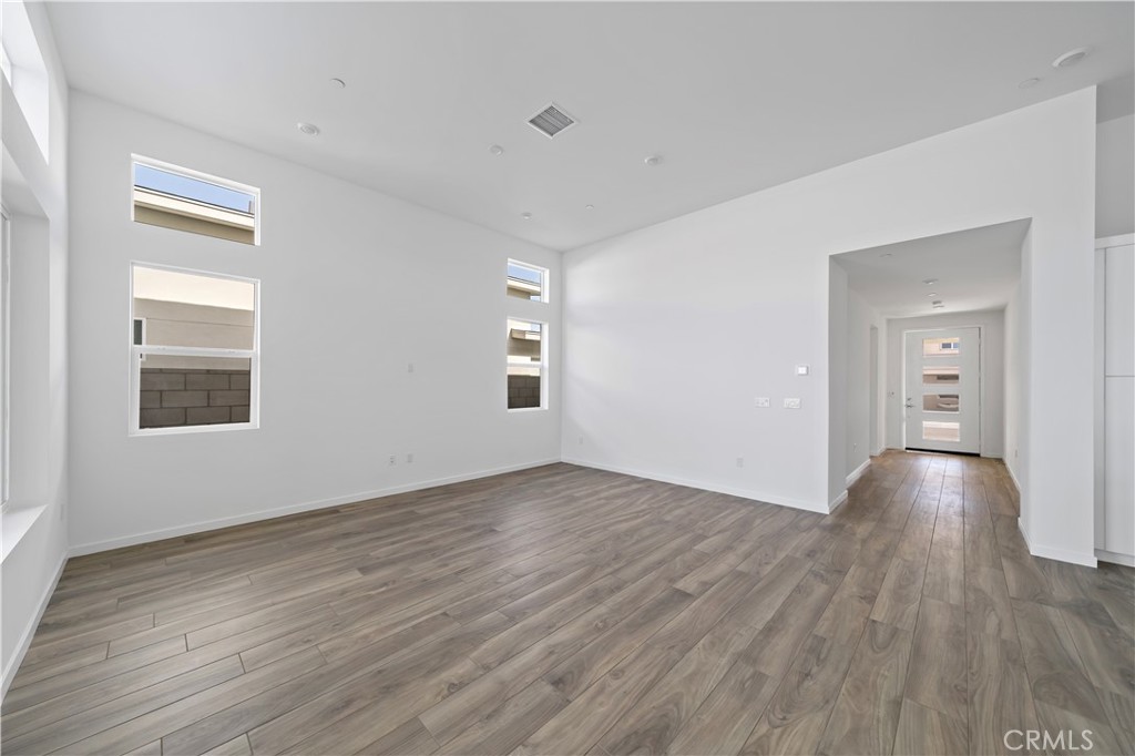 280 Mustang Lane Palm Springs, CA 92262 - Photo 11 of 12 a view of an empty room with wooden floor and a window