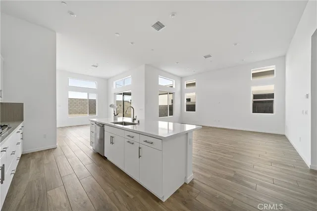 a kitchen with granite countertop a sink and a stove top oven