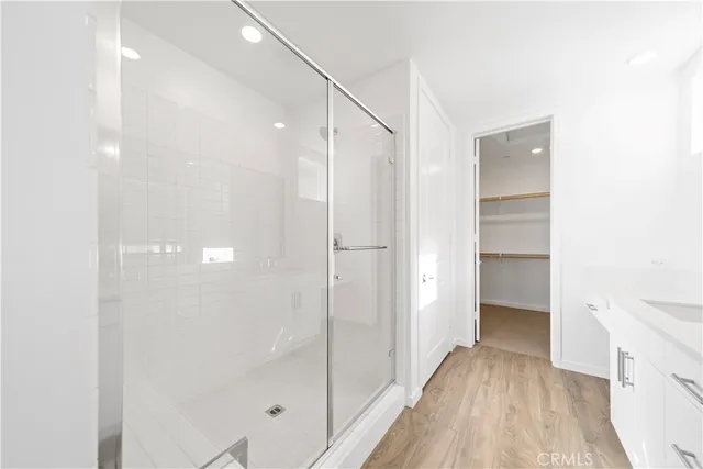 a bathroom with a shower and a glass door