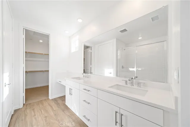 a bathroom with a sink double vanity and a mirror
