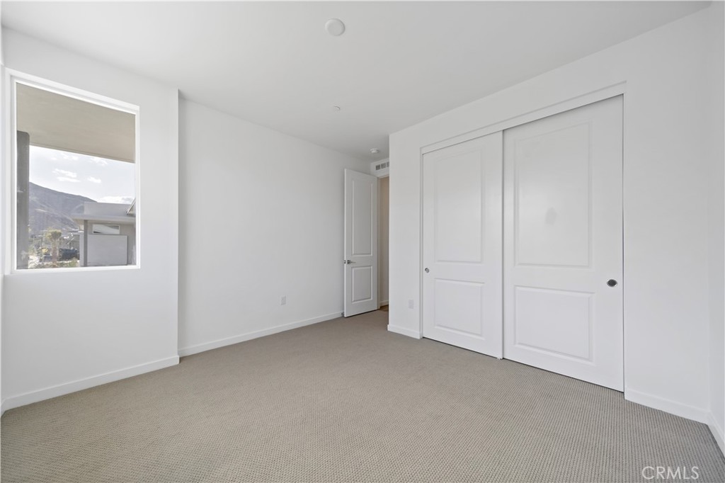 280 Mustang Lane Palm Springs, CA 92262 - Photo 10 of 12 a view of an empty room with a window