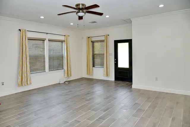 wooden floor in an empty room with a window