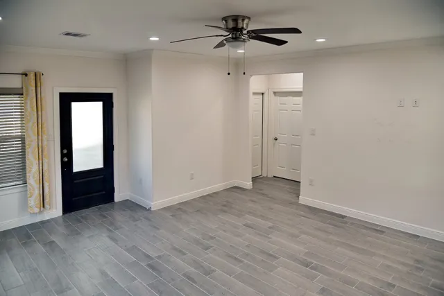 a view of hallway with wooden floor