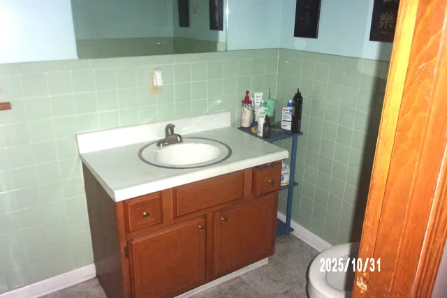 a bathroom with a sink a toilet and a mirror