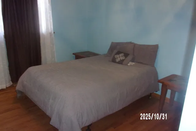 a bed sitting in a bedroom next to a window