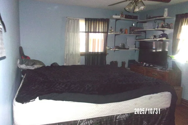 a bed sitting in a room next to a window