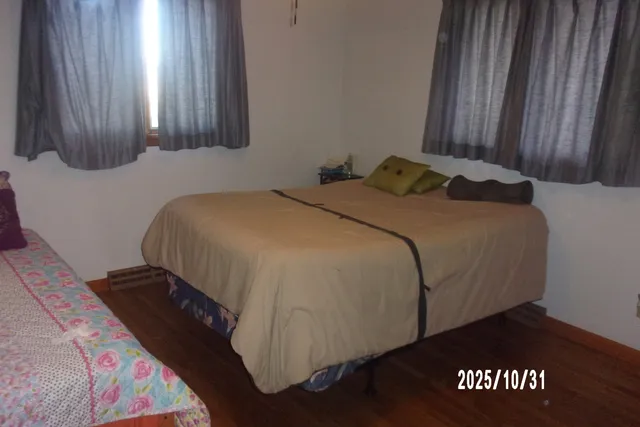 a bed sitting in a bedroom next to a window