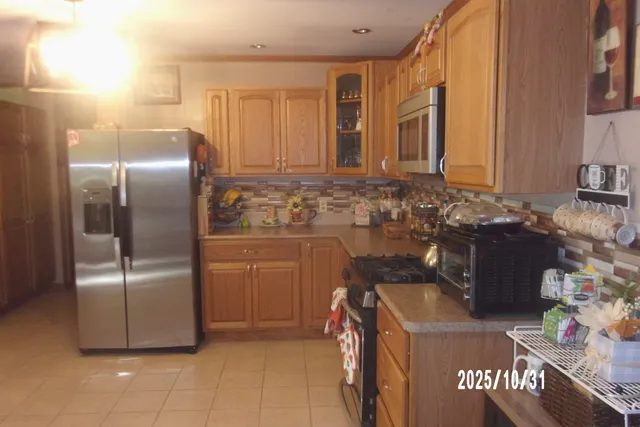 a kitchen with refrigerator and cabinets