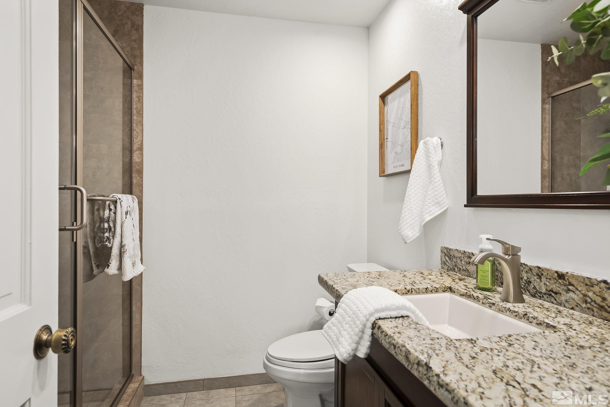 655 Canyon Circle Reno, NV 89519 - Photo 27 of 39 a bathroom with a granite countertop sink toilet and mirror