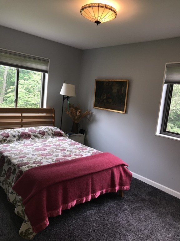 75 Spaulding Street, Unit 75 Amherst, MA 01002 - Photo 20 of 36 a bedroom with a bed and a chandelier