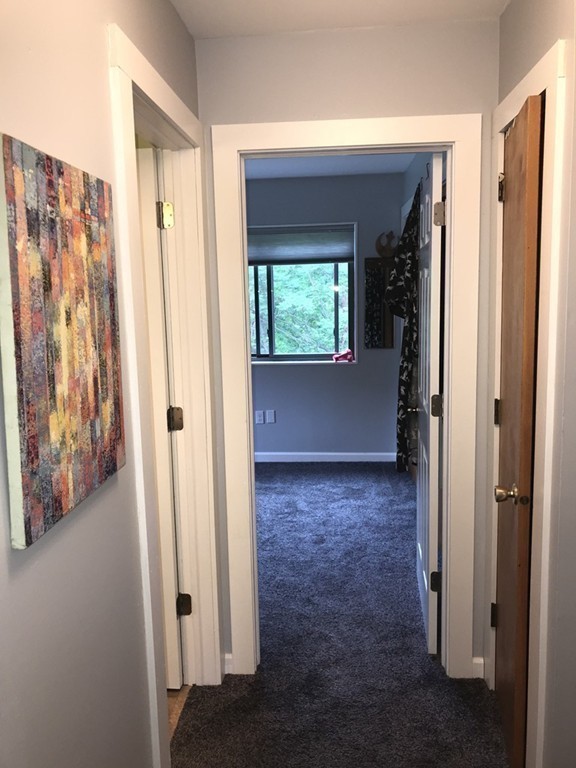 75 Spaulding Street, Unit 75 Amherst, MA 01002 - Photo 28 of 36 wooden floor and window in an empty room