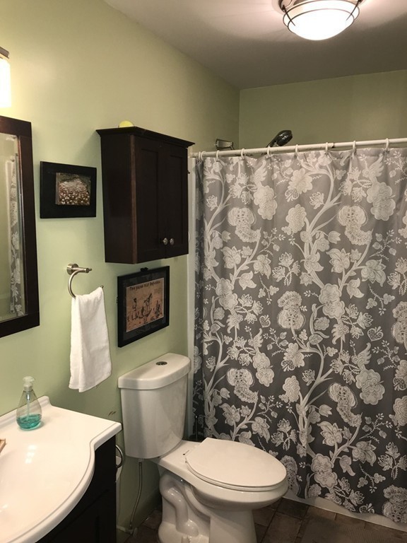 75 Spaulding Street, Unit 75 Amherst, MA 01002 - Photo 29 of 36 a white toilet sitting next to a bathroom sink and a granite counter top