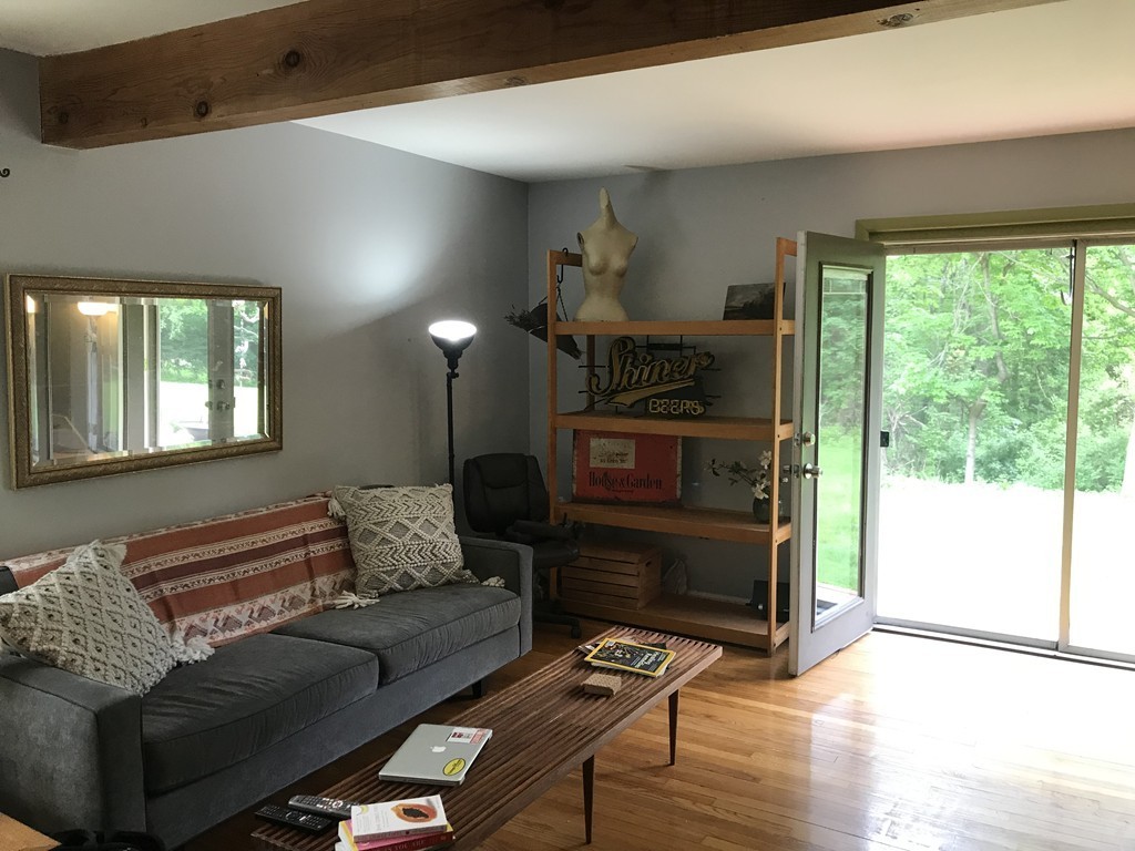 75 Spaulding Street, Unit 75 Amherst, MA 01002 - Photo 7 of 36 a living room with furniture and a fireplace