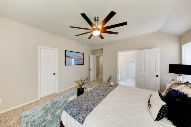 a spacious bathroom with a mirror and a sink
